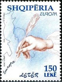 Hand holding quill pen, map of Albania and Adriatic region