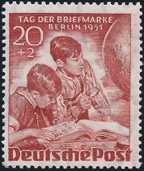 Boys with stamp album, globe